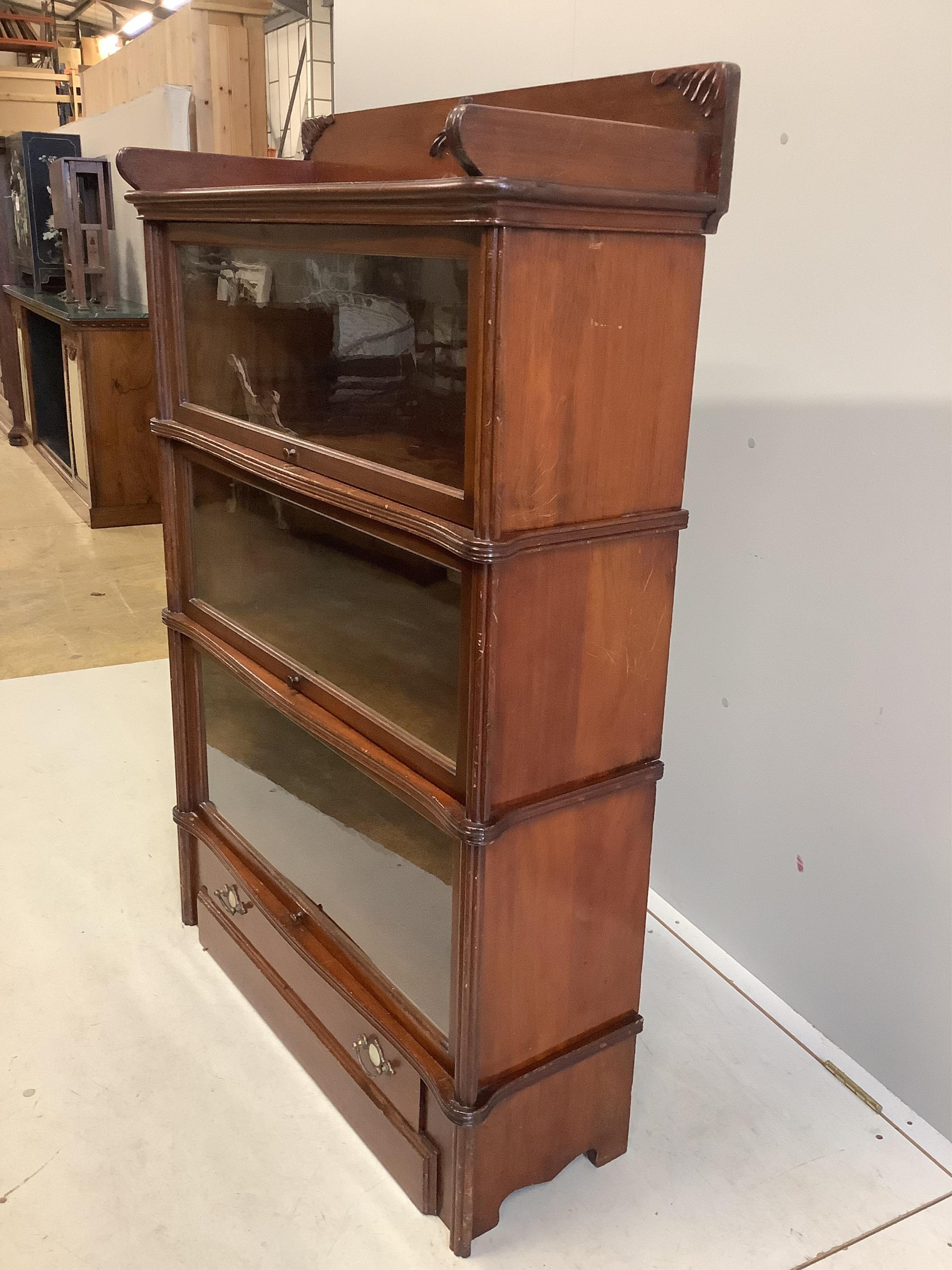 A Globe Wernicke mahogany three section bookcase, width 92cm, depth 33cm, height 135cm. Condition - fair